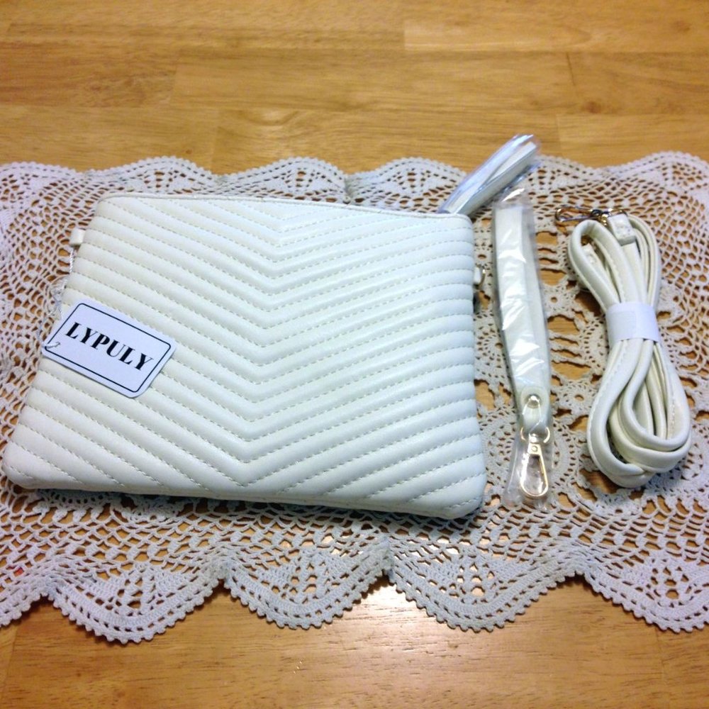 Synthetic leather purse with wrist hang and crossbody strap